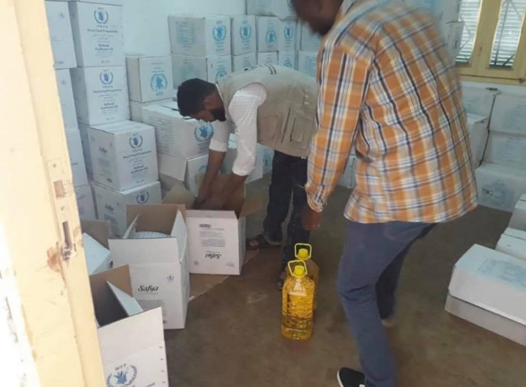 Distributing relief food baskets to affected families in southern Libya